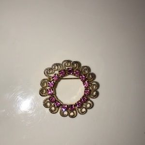 Pink and gold colored antique brooch